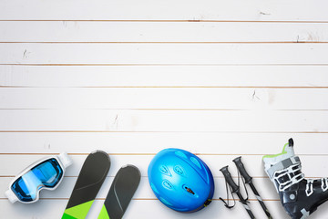 Winter ski equipment on white wooden table with copy space above. Concept of ski services and...
