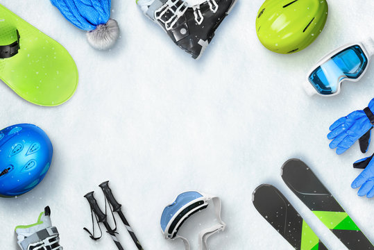 Winter ski sport accessories placed on snow with copy space in the middle for text or logo promotion. Top, view, flat, lay. Winter ski vacation concept