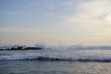  the beach in the afternoon with calm waves and sunny weather against a backdrop of open sea and coral
