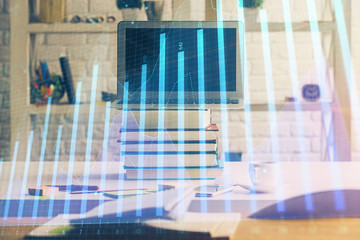 Financial chart drawing and table with computer on background. Double exposure. Concept of international markets.