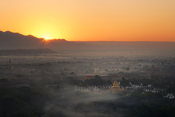 Top view of Mandalay city from Mandalay hill at the sunrise time that the sky turned orange