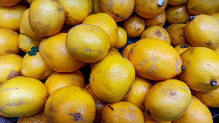 Healthy and organic oranges at the market. Lots of fresh orange fruits background.