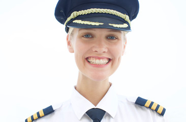 portrait of professional female pilot smiling wearing uniform. 