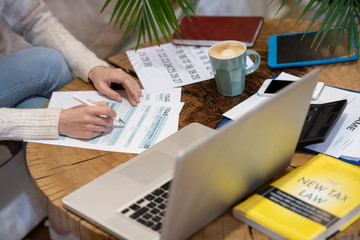 Woman working on reporting on taxes paid annually