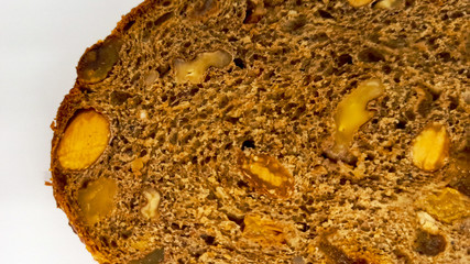 Slice of Homemade Christmas bread with almond, dried fruits and spices