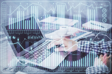 Double exposure of forex chart with man working on computer on background. Concept of market analysis.