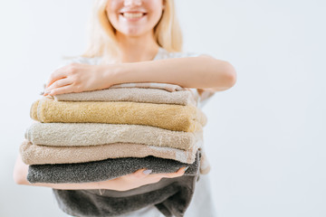 Light picture of lovely young blond housewife with cafe colorful towels on white background....