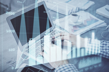 Double exposure of forex graph with man working on computer on background. Concept of market...