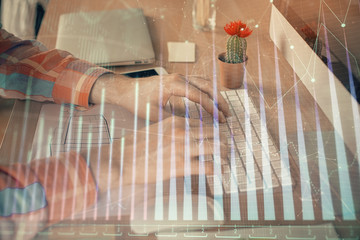 Fototapeta na wymiar Double exposure of stock market chart with man working on computer on background. Concept of financial analysis.
