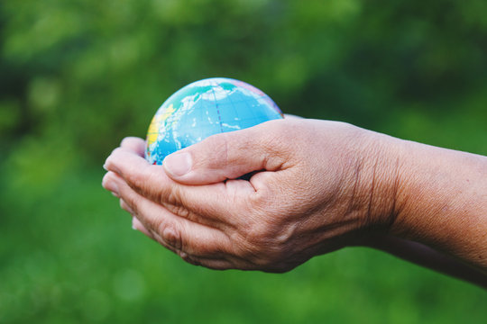 world environment day, senior woman's hands holding earth globe, earth day