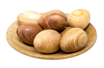 Hand-turned wooden eggs in a smal wooden bowl