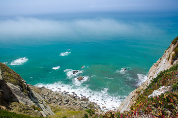 Portugal, Cabo da Roca, The Western Cape Roca of Europe, white clouds over the Atlantic ocean, ocean view from the Cape  Roca, cliff above the Atlantic ocean, azure water in the Atlantica