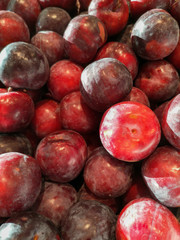 Ripe plum in the store as a background