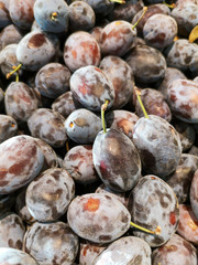 Ripe plum in the store as a background