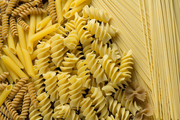 Variety of types and shapes of Italian raw pasta