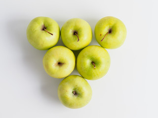 Top view of organic green apples isolated on white background.