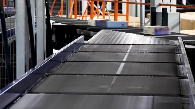 Parcels are moving on belt conveyor at post sorting office