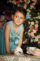 Beautiful little girl having a tea party.
