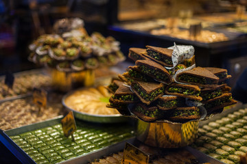 delicious street food and deserts in Istanbul city, Turkey Traditional oriental sweet pastry cookies, Turkish desert with sugar, nuts, chocolate honey and pistachio in display at a street food market
