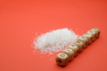 Health concept. Sugar with a DIABETES wording on red background