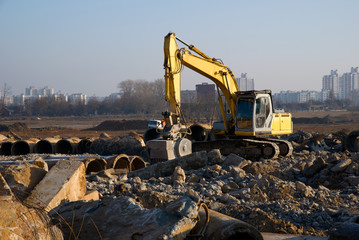 Excavator with crusher bucket for crushing concrete. Construction waste recycling for construction...