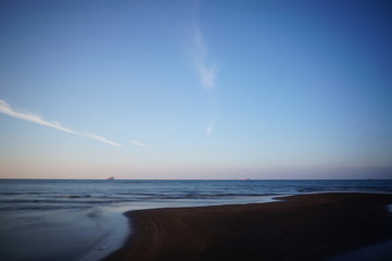 The beach in the afternoon has a relaxed atmosphere and the sea experiences low tide