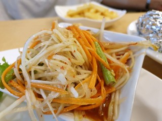 Thai food style, Selective focus of papaya salad with tomato, shrimp, chili and bean on white plate as a background, This food is most popular, Som Tum is Thai traditional