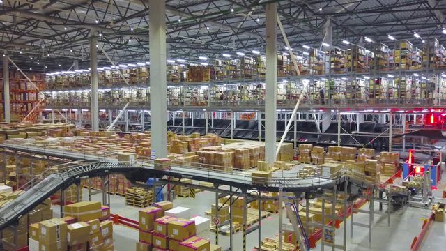 Industrial interior big modern logistic terminal,conveyor with boxes,aerial shot