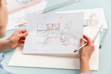 Interior designer drawing pencil sketch of a kitchen