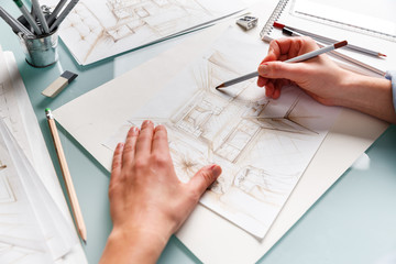 Interior designer drawing pencil sketch of a kitchen