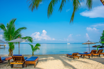 Fototapeta na wymiar Chairs and Umbrella on beautiful beach.