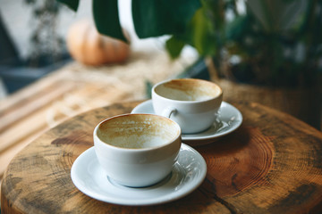 Two empty cups after drinking coffee on a wooden table. Concept for ending a meeting or something...