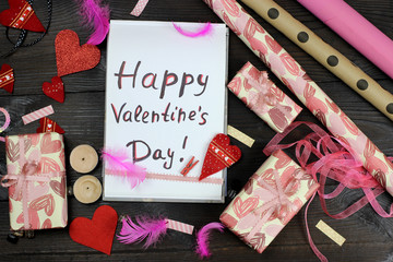 Gift wrapping paper and hearts. Notebook with the inscription Happy Valentine's Day