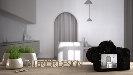 Architect photographer designer desktop concept, camera on wooden work desk with screen showing interior design project, blurred scene background, modern white kitchen idea template