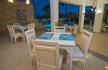 Interior of a luxury hotel restaurant by swimming pool
