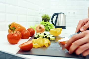 woman cutting vegetables in the kitchen