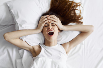 woman having a headache in bed