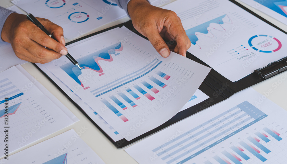 Aufkleber businessman working calculate data document graph chart report marketing research development planni