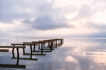 Fototapeta premium old dock in the lake at sunrise