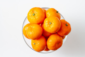 tangerines in a bowl isolated on white background