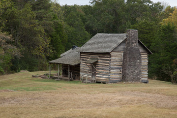 Fototapeta na wymiar Weathered log cabin with a porch