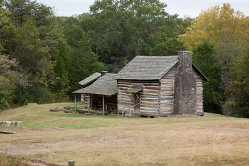 Log Cabin in a field of grass