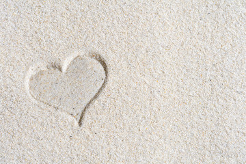 Drawn Valentines heart on the sand at the beach. Concept
