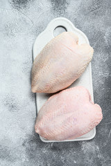 Raw chicken Breasts, fresh fillets with skin. Organic farm bird. Gray background