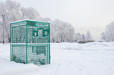 Green metal container for collecting plastic bottles installed i