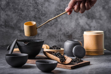 Ceramic tea pot and cups with the famous Photo in the room Chinese tea ceremony on dark background