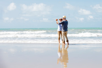 Happy asian couple dancing on the beach enjoy  life