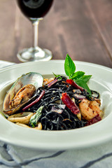 Black seafood spaghetti. Black food still life