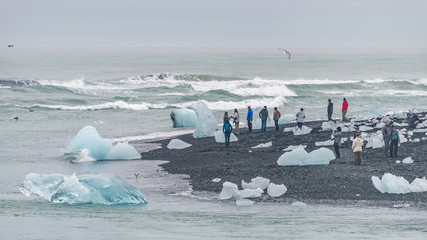 Touristic activity in Glacier Lagoon Jokulsarlon with icebergs in Iceland, summer