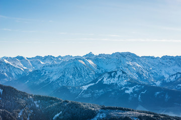 Fototapeta na wymiar Aerial view of winter mountain landscape with snow covered peaks. Bavarian mountains in the Allgaeu area near Oberstdorf, Germany